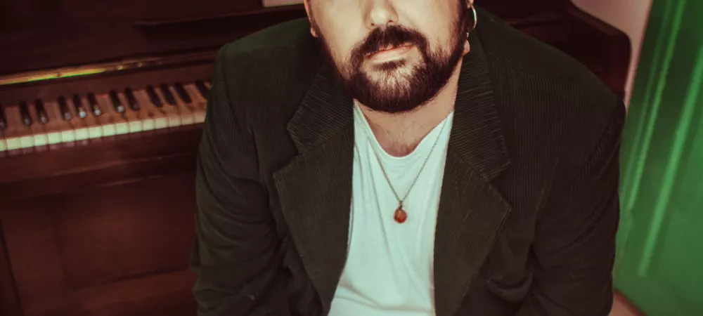 Yo sentado. Atras mio un piano vertical abierto con una partitura en el atril