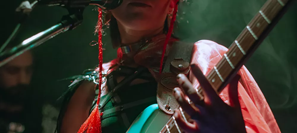 Foto en vivo tocando la guitarra con luces verdes